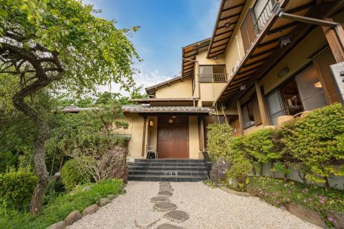 a house with a staircase leading to a door at プライベートリゾート伊豆 in Izunokuni