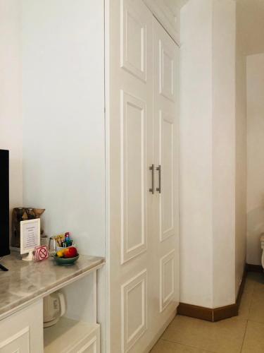 a white door in a kitchen with a counter at Casa Blanca Boutique Hotel - SHA Plus in Phuket Town