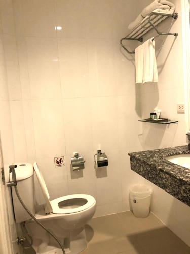 a bathroom with a toilet and a sink at Casa Blanca Boutique Hotel - SHA Plus in Phuket Town