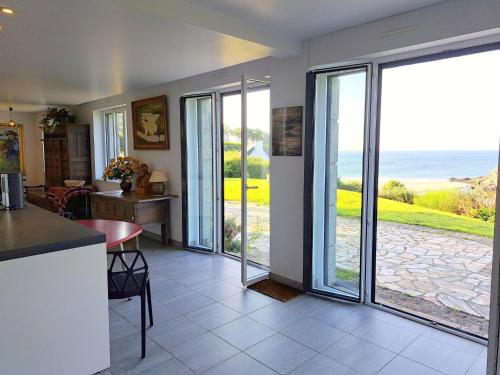 a kitchen and dining room with sliding glass doors at Villa in Brittany with Panoramic Sea Views in Névez