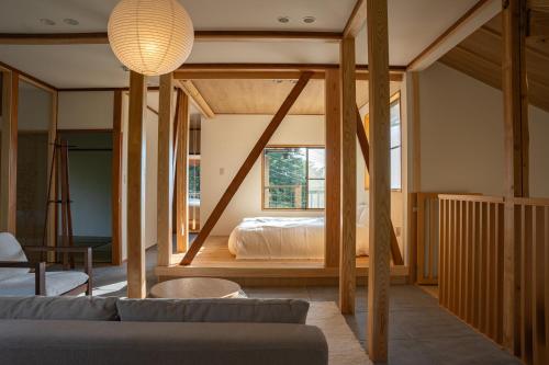 a living room with a bed and a couch at プライベートリゾート伊豆 in Izunokuni