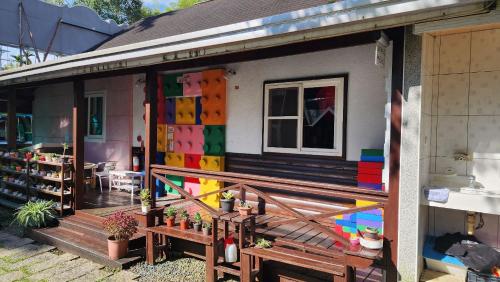 a house with colorful paint on the side of it at 杉溪鹿莊園-溪頭獨棟式小木屋 & 如需溜滑房型請選請選家庭房 in Lugu