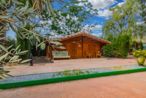 un edificio de madera en medio de un patio en Alojamiento rural Caserio de la Fuente, en Deifontes