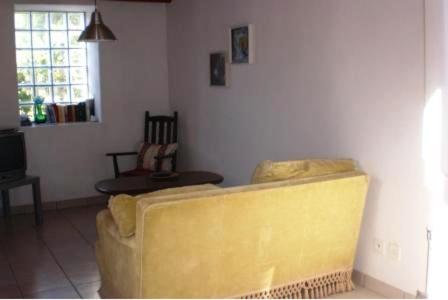 a yellow couch sitting in a living room at Rustico Il Nido in Maggia