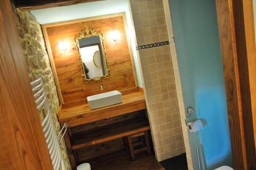 a bathroom with a sink and a mirror at Le Presbytère in Soy
