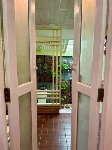 an open door to a room with a courtyard at Baan Bua Cottage SHA EXTRA PLUS B5510 in Ko Kood