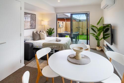 a room with a bed and a table and chairs at Family Friendly Near Waltham Pool in Christchurch