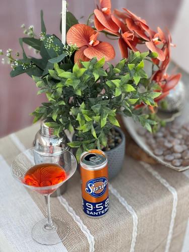 a table with a vase of flowers and a can of soda at La Casa del Vagabondo in Belvedere