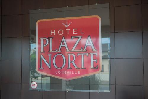 a sign in a window of a hotel playa nore at Hotel Plaza Norte in Joinville