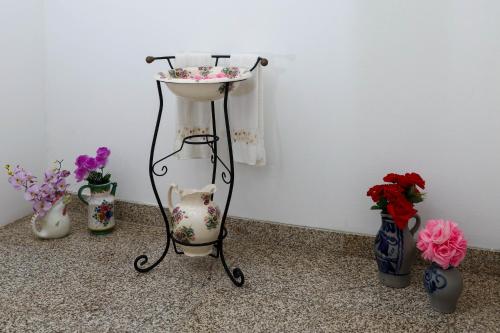 a sink in a room with vases at Casa grande Covelinhas in Covelinhas