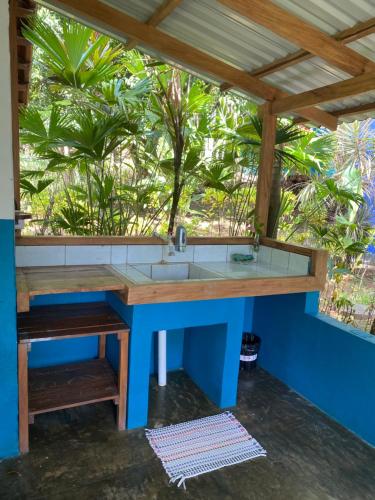 a bathroom with a sink in a room with trees at Rancho Burica in Pavones