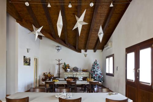 a dining room with a christmas tree and stars on the ceiling at La Corte D'Emilio B&B in Vignola