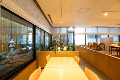 an office with a long table and chairs and tables at Onomichi Kokusai Hotel in Onomichi