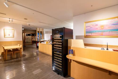 a waiting room with a desk and a table at Onomichi Kokusai Hotel in Onomichi