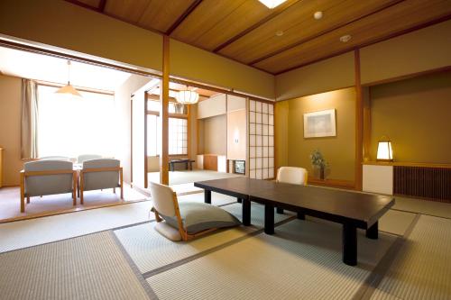 a dining room with a table and chairs at Miyajima Grand Hotel Arimoto in Miyajima