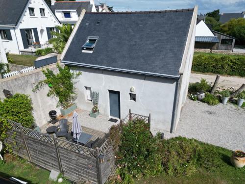a man sitting on a porch of a house at La grange du Manemeur in Quiberon