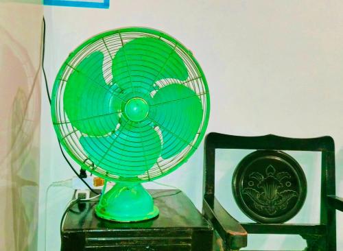 a green fan sitting on top of a table at Zhuge Hospitality Homestay in Tainan