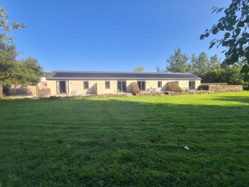 a house with a large lawn in front of it at The Stables by Blake View Holidays, comprising The Nest, The Drey, The Burrow and the Den, 3 miles from Ennerdale in Rowrah