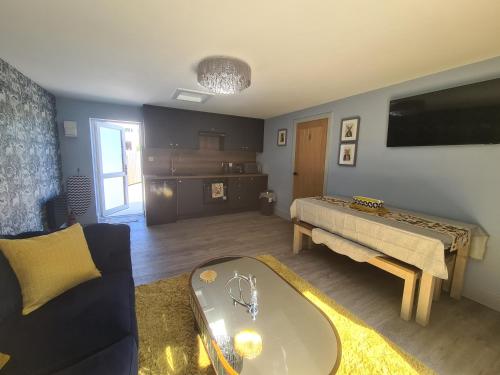 a living room with a couch and a table at The Stables by Blake View Holidays, comprising The Nest, The Drey, The Burrow and the Den, 3 miles from Ennerdale in Rowrah