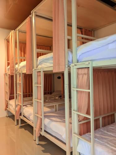 a group of bunk beds in a room at Tata Surf Hostel in Kuta Lombok