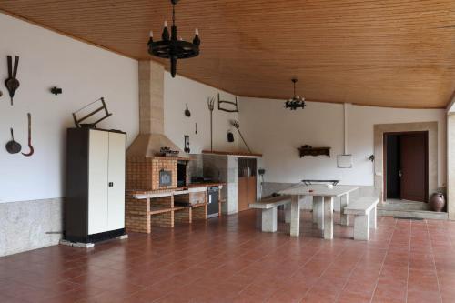 a large room with a kitchen with a table at Casa grande Covelinhas in Covelinhas