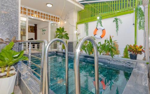 a swimming pool in a house with plants at Rio 02 homestay in Vung Tau