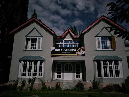 a house with a sign that reads not cure herpeslez at Rus Olive Lodge Skardu in Skardu