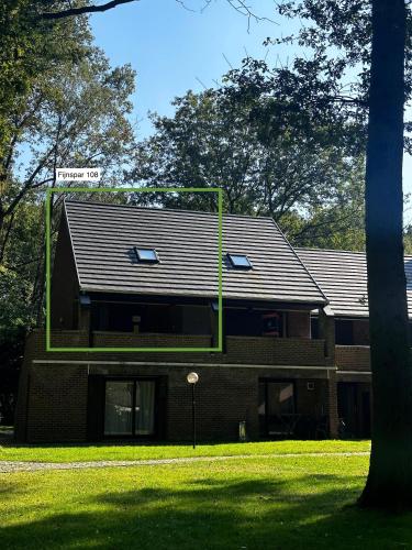 a brick building with a sign on top of it at Bos-Chalet bij Wijers Wandelroutes, Rust & Gezinsplezier Fijnspar 108 Hengelhoef in Houthalen-Helchteren