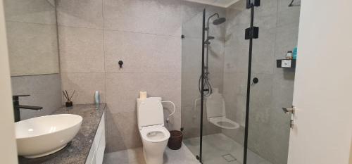 a bathroom with a shower and a toilet and a sink at המטרופולו in Caesarea