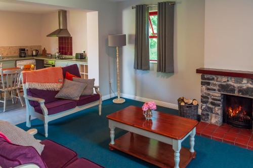 a living room with a couch and a fireplace at Lough Lannagh Self Catering Cottages in Castlebar
