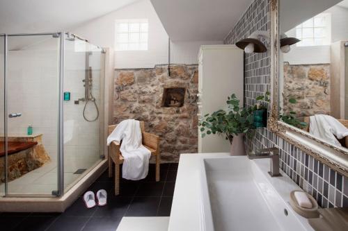 a bathroom with a shower and a tub and a sink at La scuola di Anna in Babino Polje