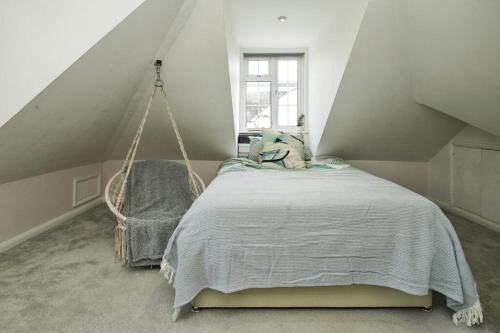 a bedroom with a bed and a swing at Carden Villa 4 Bedroom House With Hot Tub Pet Friendly in Brighton & Hove
