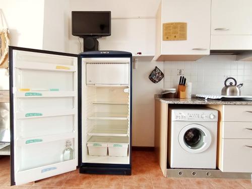 a kitchen with a refrigerator and a washing machine at Le Casine di Tuscany Maremma Saturnia in Catabbio