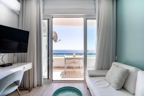 a living room with a view of the ocean at Sea Lovers - Sea front - studio apartment in Monte Gordo