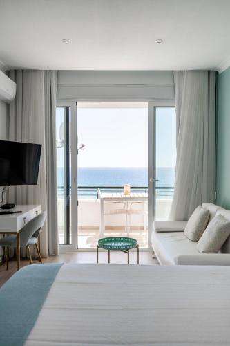 a bedroom with a bed and a view of the ocean at Sea Lovers - Sea front - studio apartment in Monte Gordo
