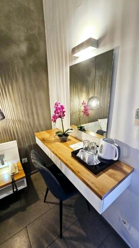 a bathroom counter with a sink and a mirror at Atlantis Boutique City Hotel in Rhodes Town