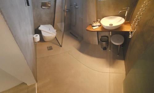 a bathroom with a sink and a toilet and a shower at Atlantis Boutique City Hotel in Rhodes Town