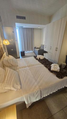 a large white bed in a hotel room at Atlantis Boutique City Hotel in Rhodes Town