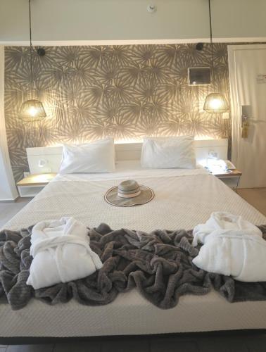 a bedroom with a bed with two towels on it at Atlantis Boutique City Hotel in Rhodes Town