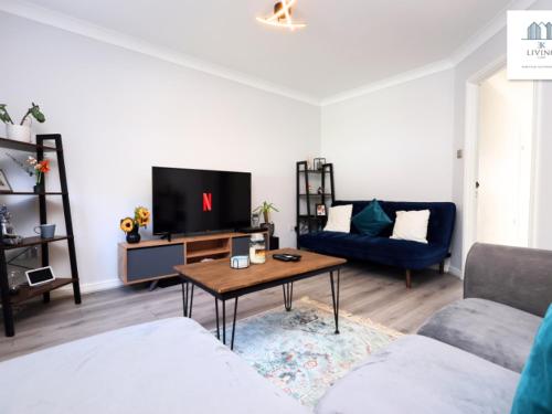 a living room with a couch and a table at Spacious 3 Bed Home In The Heart Of Bridgend - By EKLIVING LUXE Short Lets & Serviced Accommodation in Bridgend