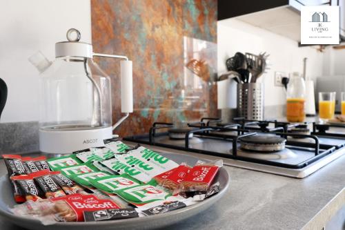 a counter with a blender and some food on a plate at Spacious 3 Bed Home In The Heart Of Bridgend - By EKLIVING LUXE Short Lets & Serviced Accommodation in Bridgend
