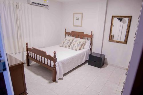 a bedroom with a bed with a mirror and a dresser at Casa Nora Alojamiento Entero, 4 Habitaciones Capacidad Máxima 9 huéspedes in Ríohacha