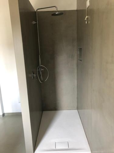 a bathroom with a shower with a white floor and a shower at Casitamia b&b in Clusane sul Lago