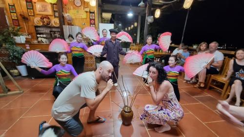 a group of people with pink umbrellas in a room at Inh La Home Pu Luong in Pu Luong