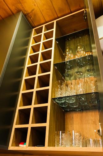 a wooden cabinet with glasses in it at Swiss House Dilijan in Dilijan