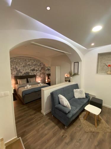 a bedroom with a bed and a couch and a bed and a bed at Apartment Frenki- Tkalčićeva -self check in-free parking in Zagreb
