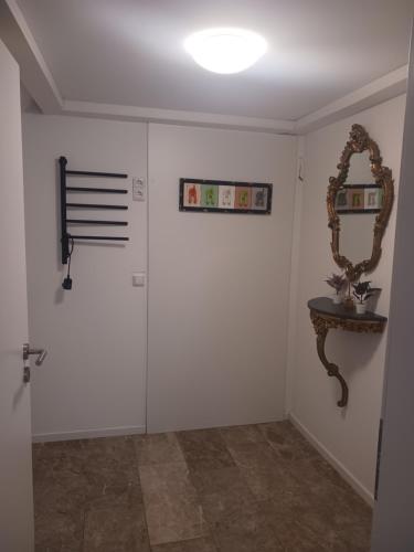 a room with white walls and a mirror and a table at Moderne Wohnung in ruhiger Lage in Stolberg
