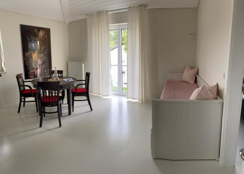 a bedroom with a bed and a table and chairs at Petit Appartement in Hapberg