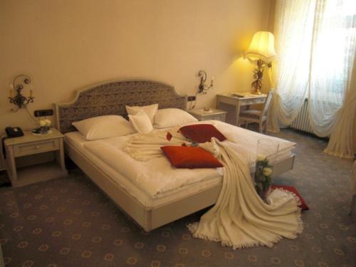 a bedroom with a bed with a dress on it at Hotel-Restaurant Drei Hasen in Michelstadt