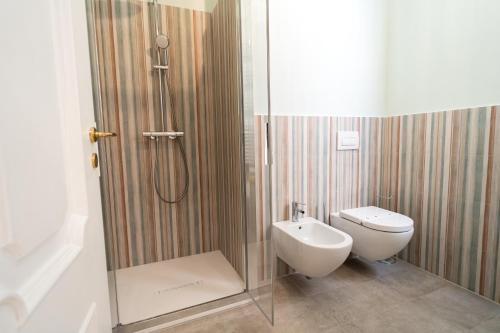 a bathroom with a shower with a toilet and a sink at Antica Loggia in Vibo Valentia